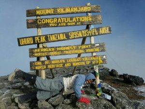 David Thuo Climbing Mt Kilimanjaro at Uhuru Peak